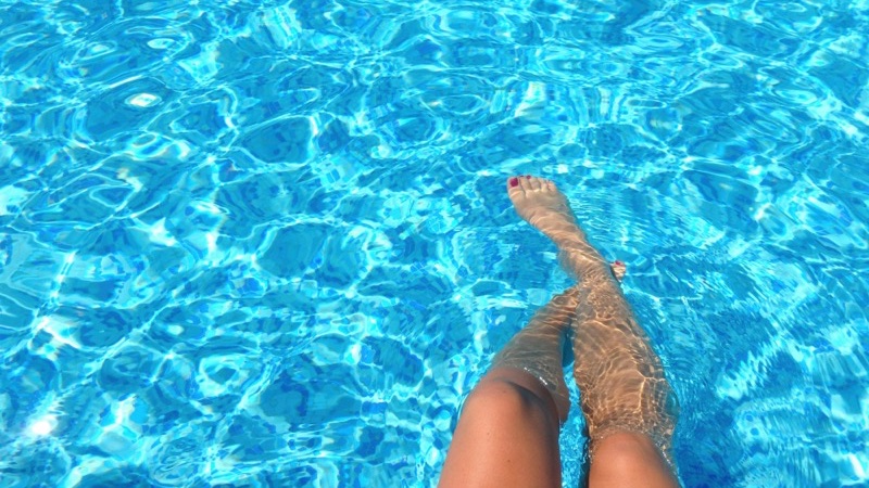 Person relaxing in a clean swimming pool